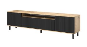 TV-Möbel / TV-Schrank mit geriffelter Front Cienequillas 02, Farbe: Eiche Artisan / Schwarz, Beine: Schwarz, Maße: 54 x 200 x 40 cm, für Wohnzimmer
